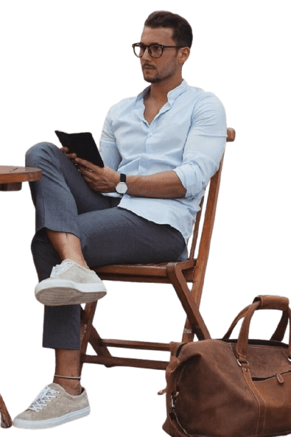 a lady putting a laptop into a brown leather laptop bag