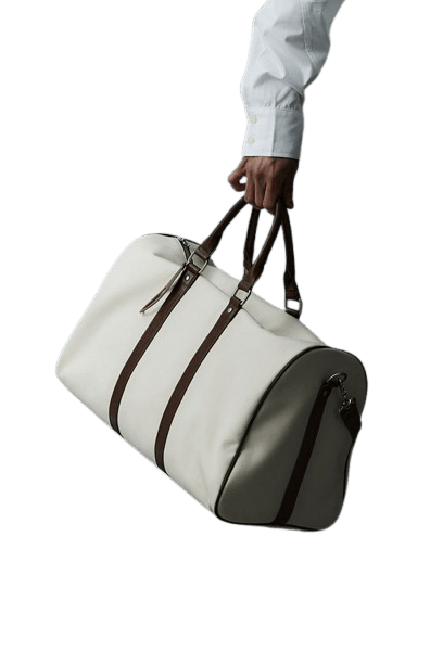 a lady putting a laptop into a brown leather laptop bag